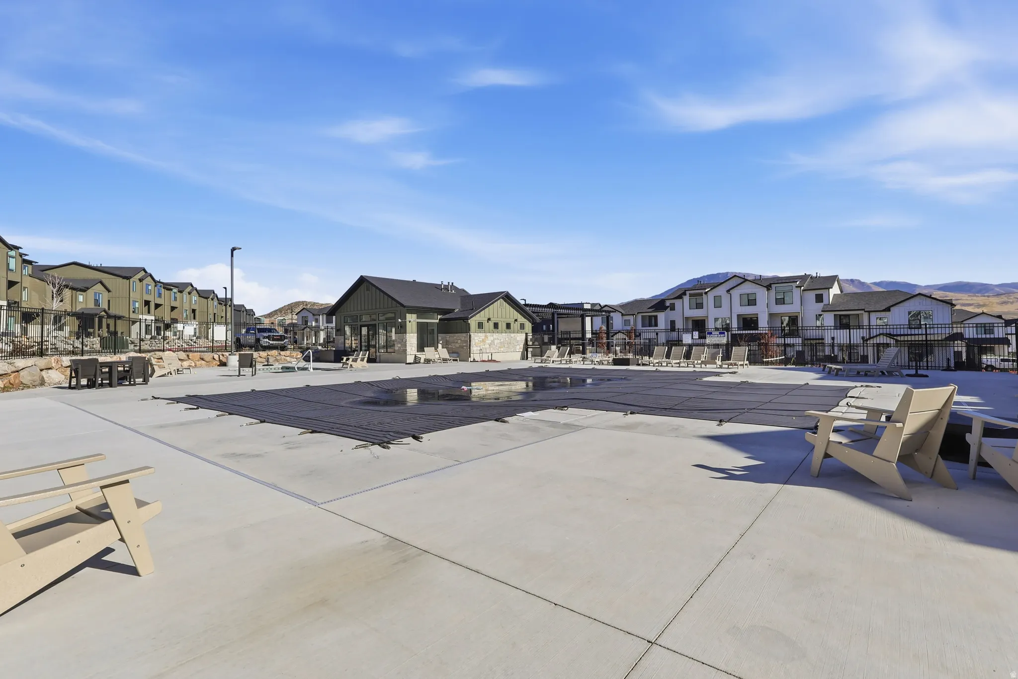 Community pool with a residential view