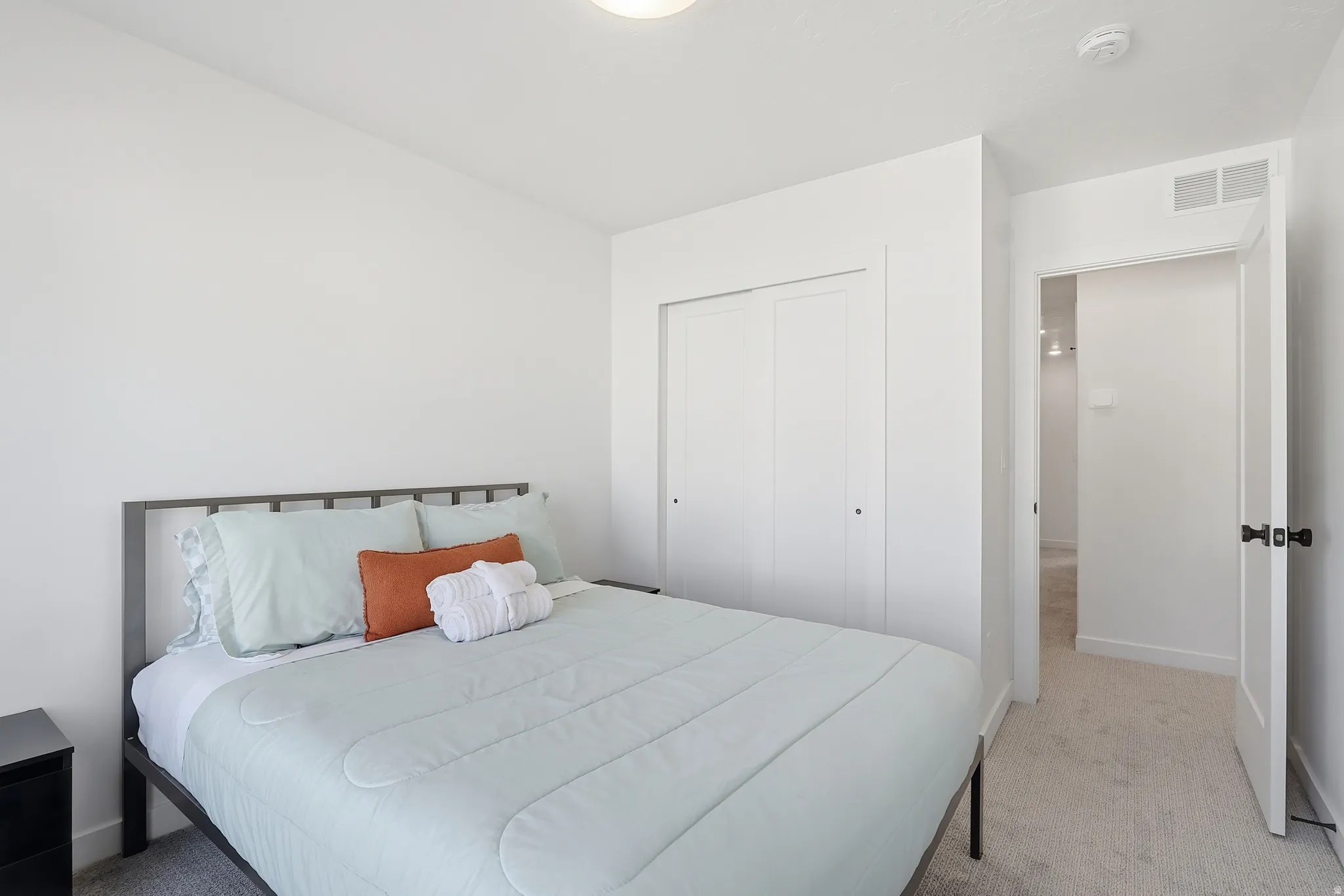 Bedroom with carpet and a closet
