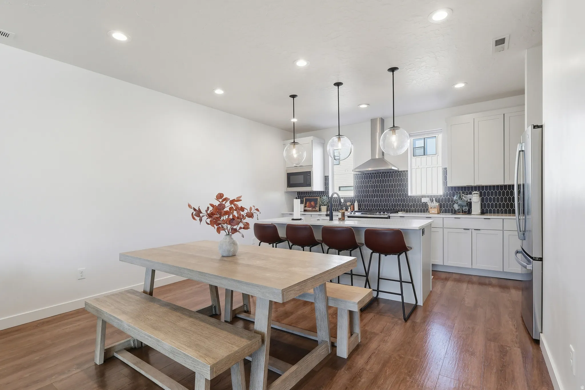 Dining room with recessed lighting and dark wood-style floors