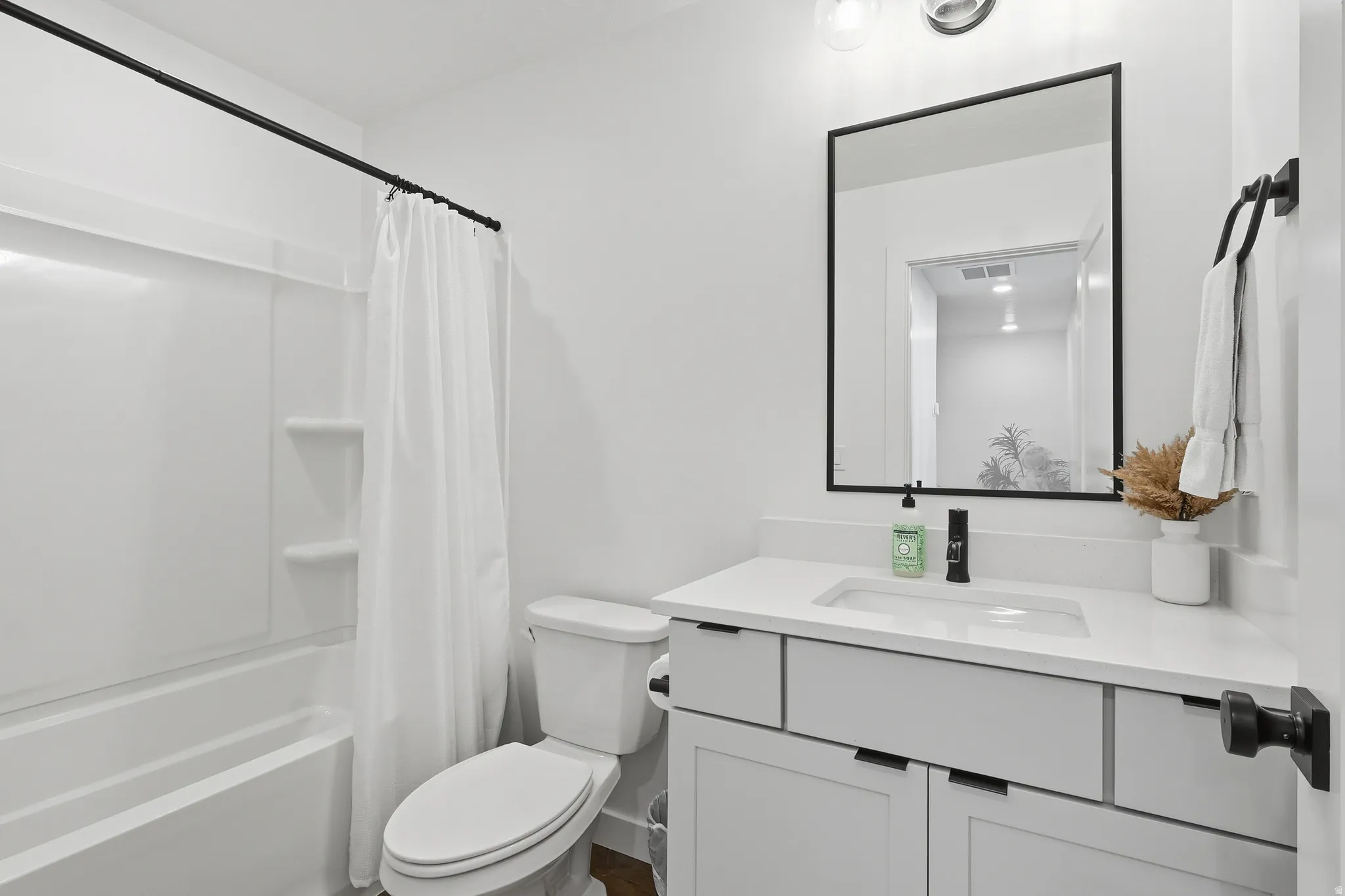 Bathroom featuring vanity and shower / tub combo with curtain