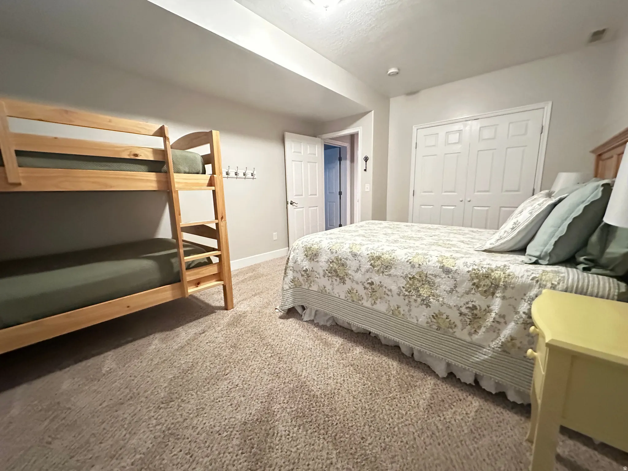 Bedroom featuring carpet and a closet