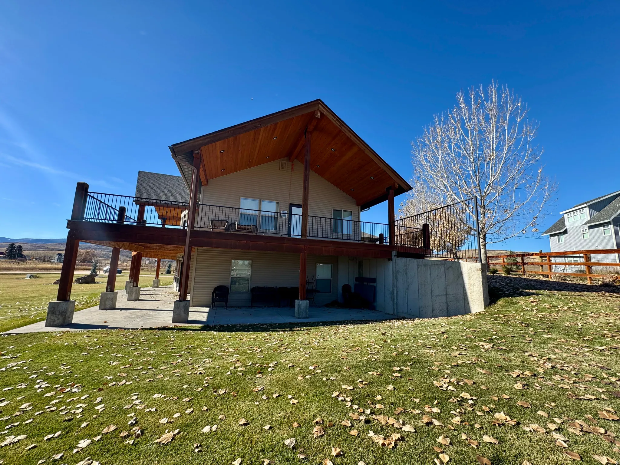 Back of property with a patio, a yard, and a deck