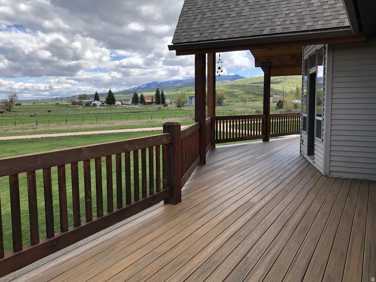 Wooden deck with a view of countryside and a mountain view