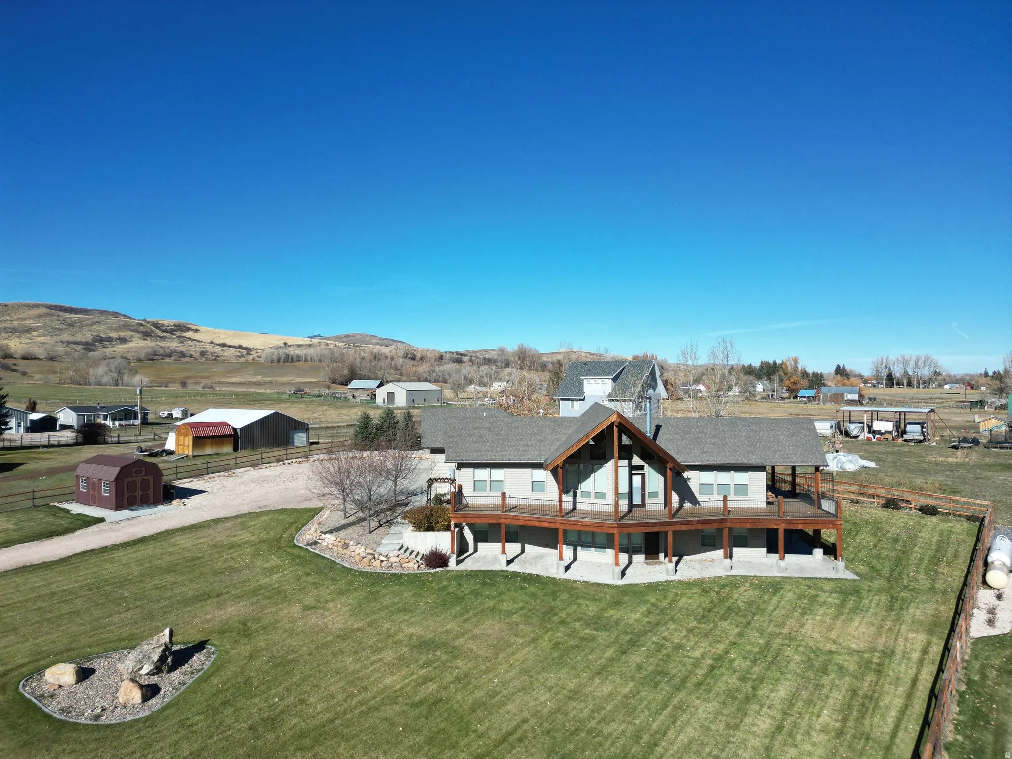 Rear view of house featuring an outdoor structure, a yard, and a patio