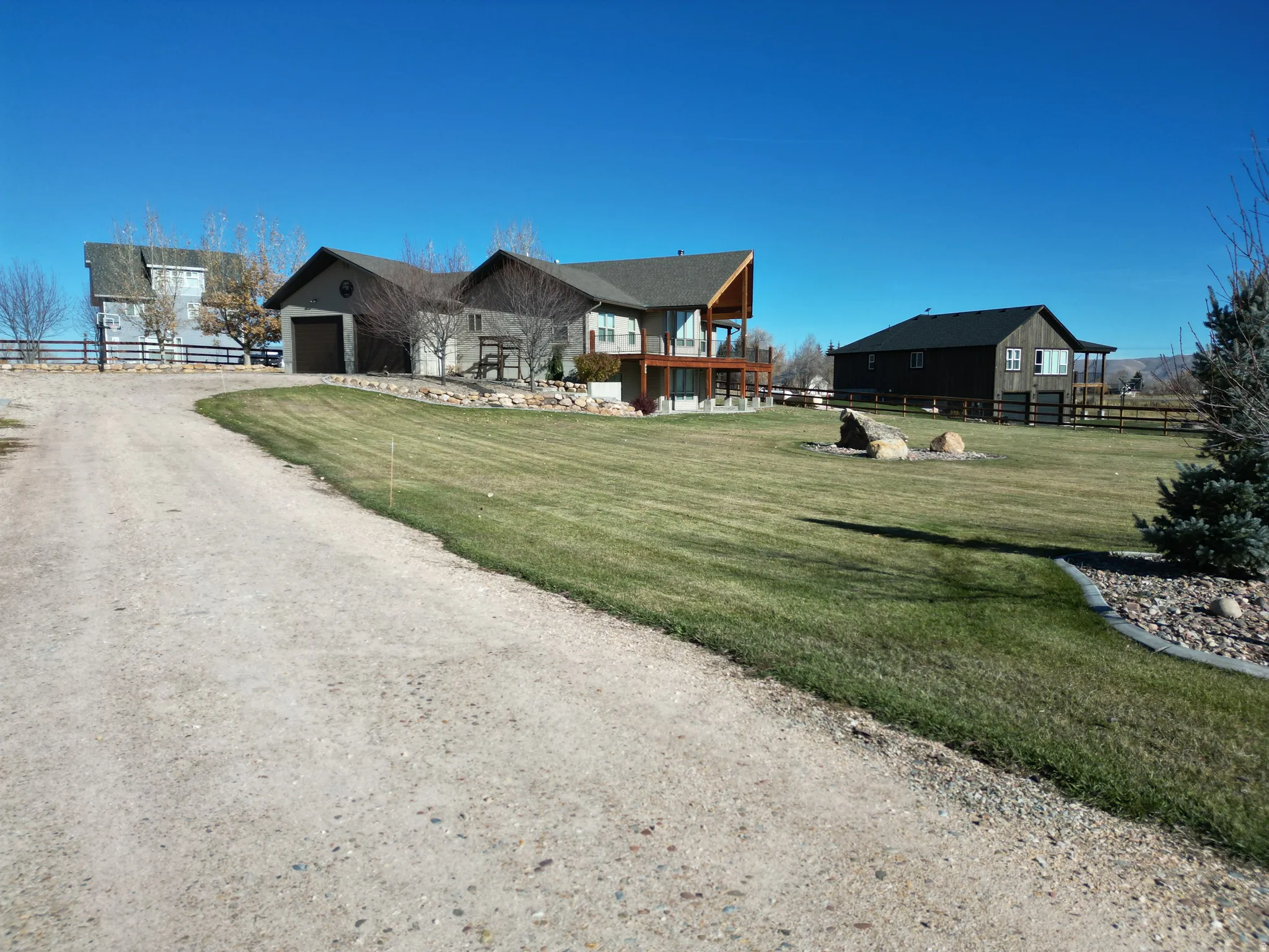 View of front of home with driveway and a balcony