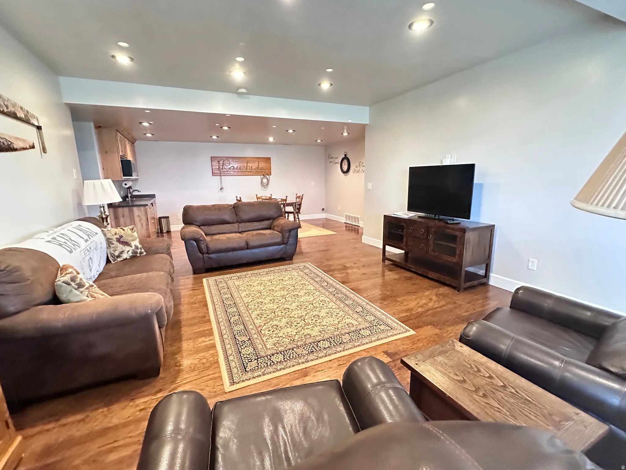 Living area featuring wood finished floors and recessed lighting