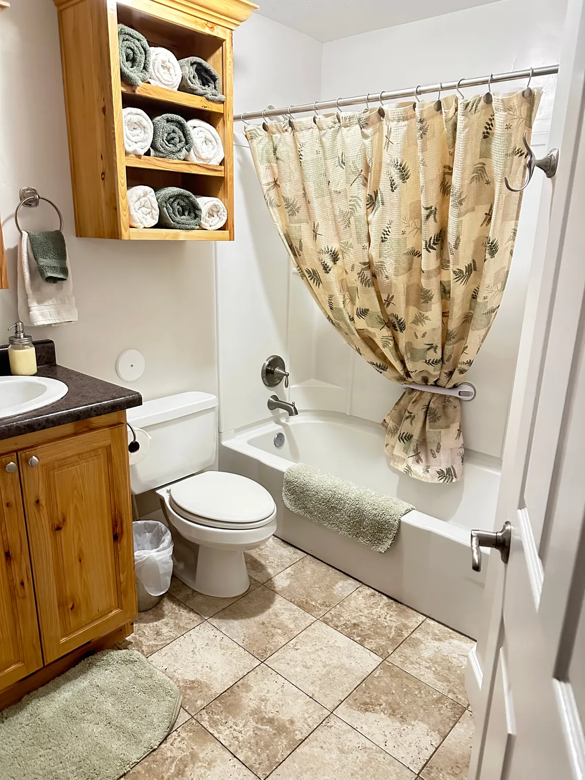 Bathroom with shower / bath combination with curtain, vanity, and light tile patterned floors
