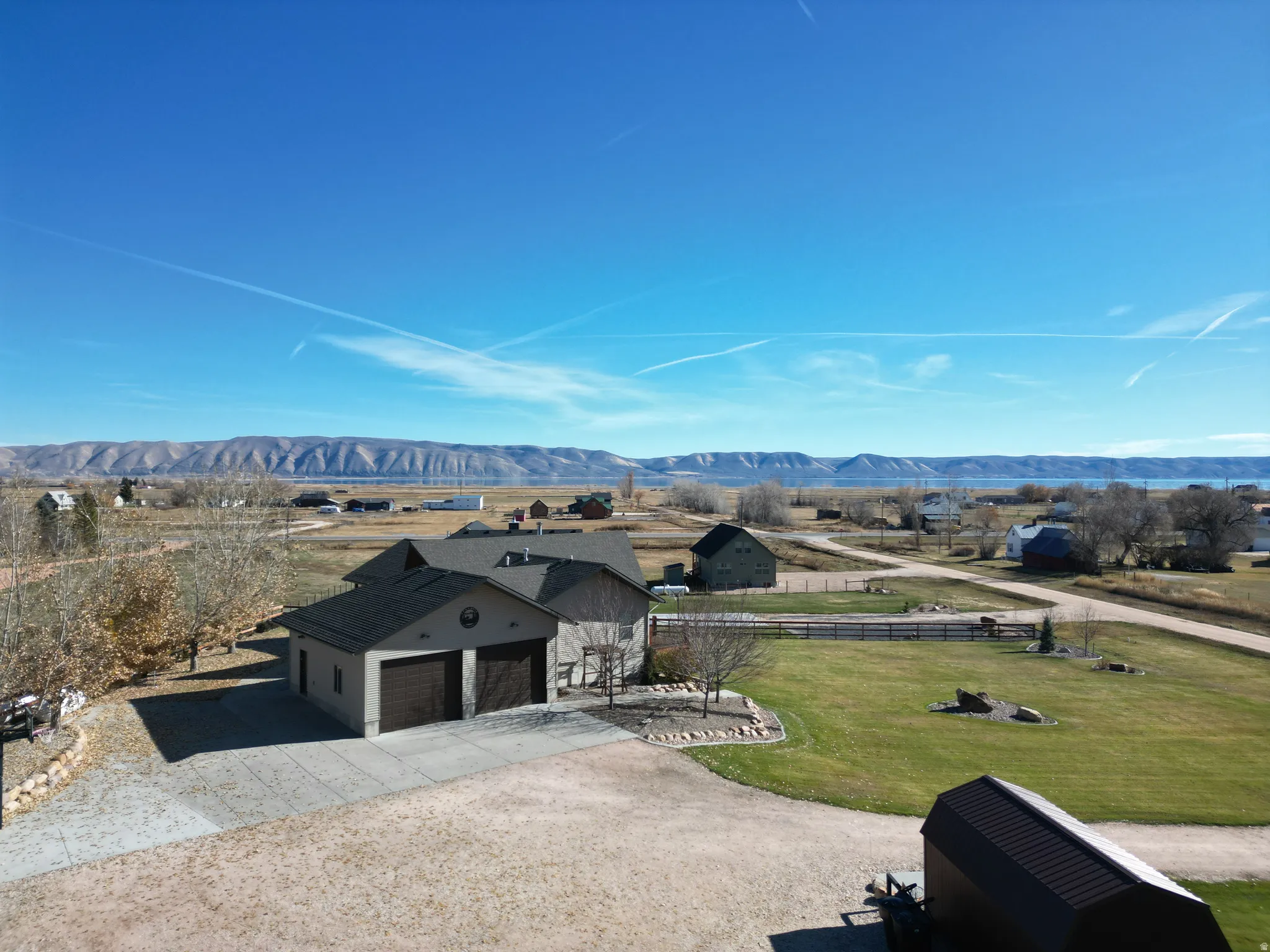 View of front facade featuring driveway, a mountain view, and a garage
