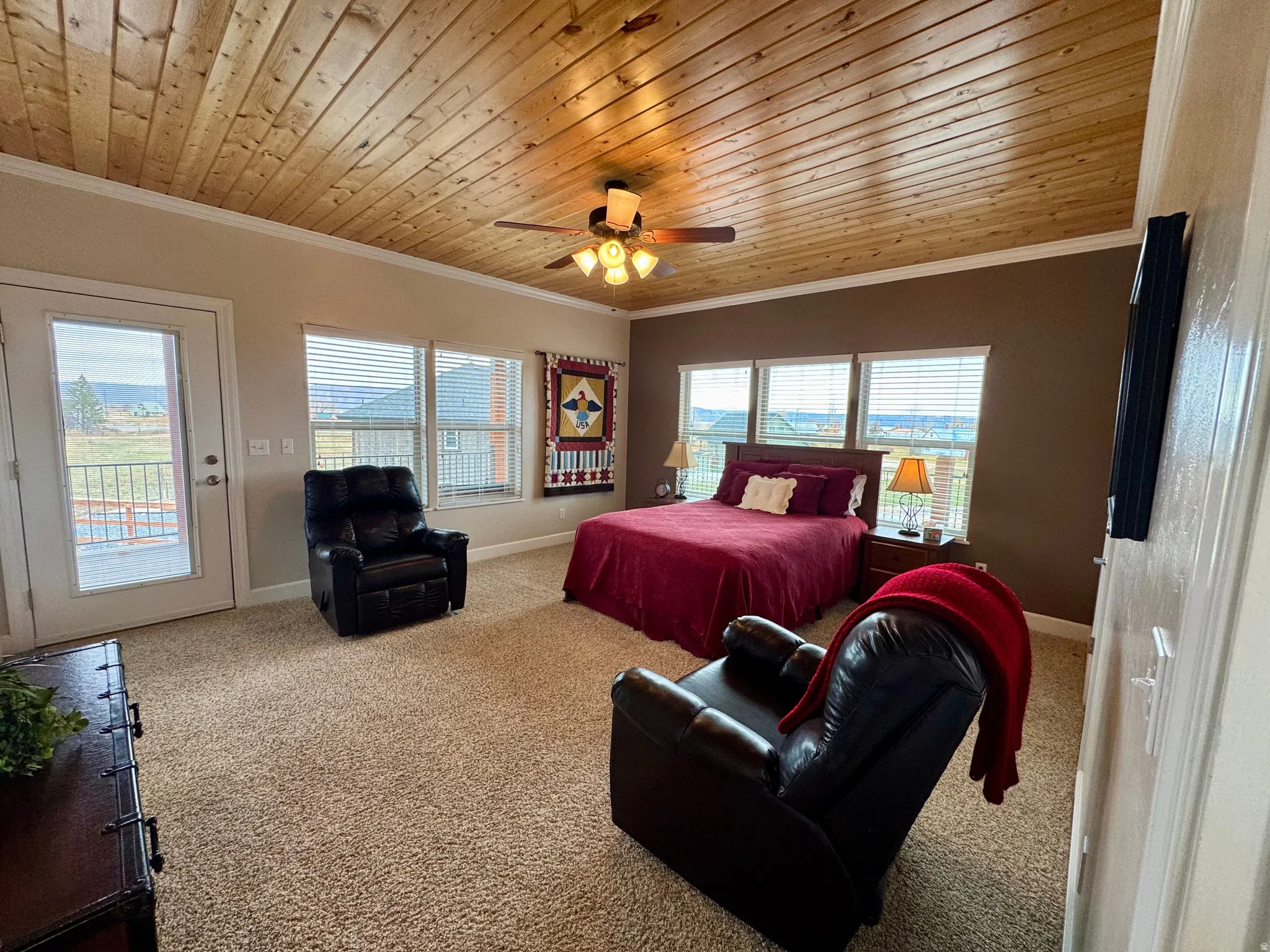 Bedroom featuring wood ceiling, ornamental molding, carpet floors, access to outside, and ceiling fan