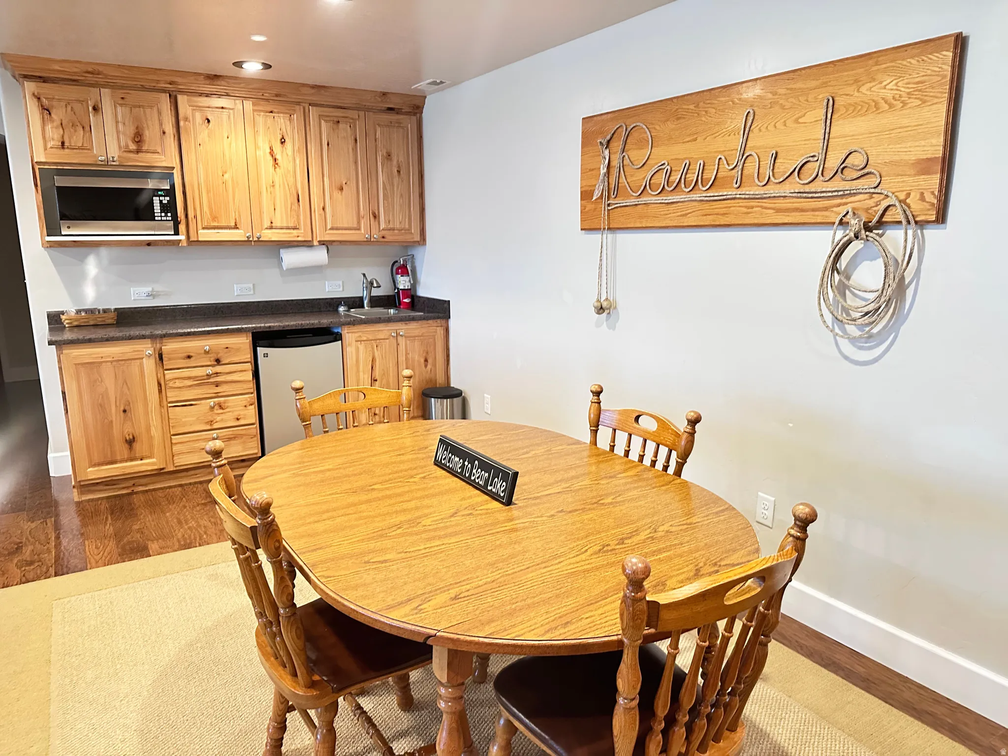 Dining area featuring dark wood finished floors and recessed lighting