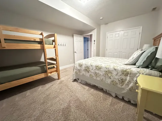 Bedroom featuring carpet and a closet