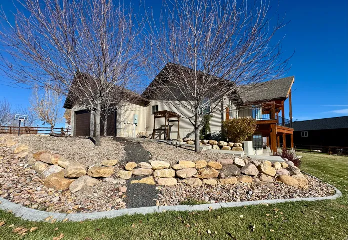 View of front of home featuring a deck and a patio