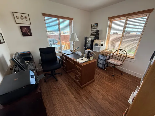 Office area with healthy amount of natural light and dark wood finished floors.  Third Bedroom