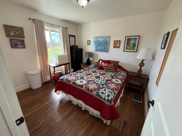 Bedroom with wood finished floors and a textured ceiling