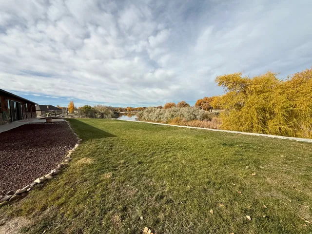 View of green lawn featuring a water view
