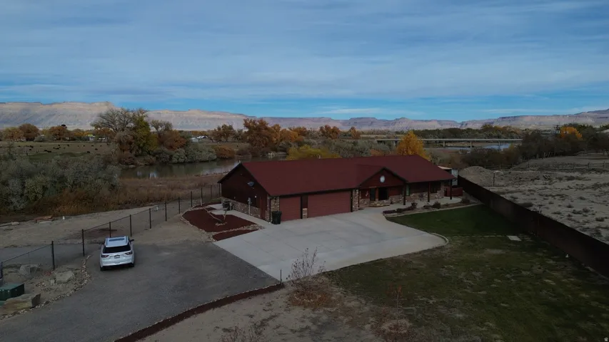 Aerial view of property and surrounding area with a mountain backdrop