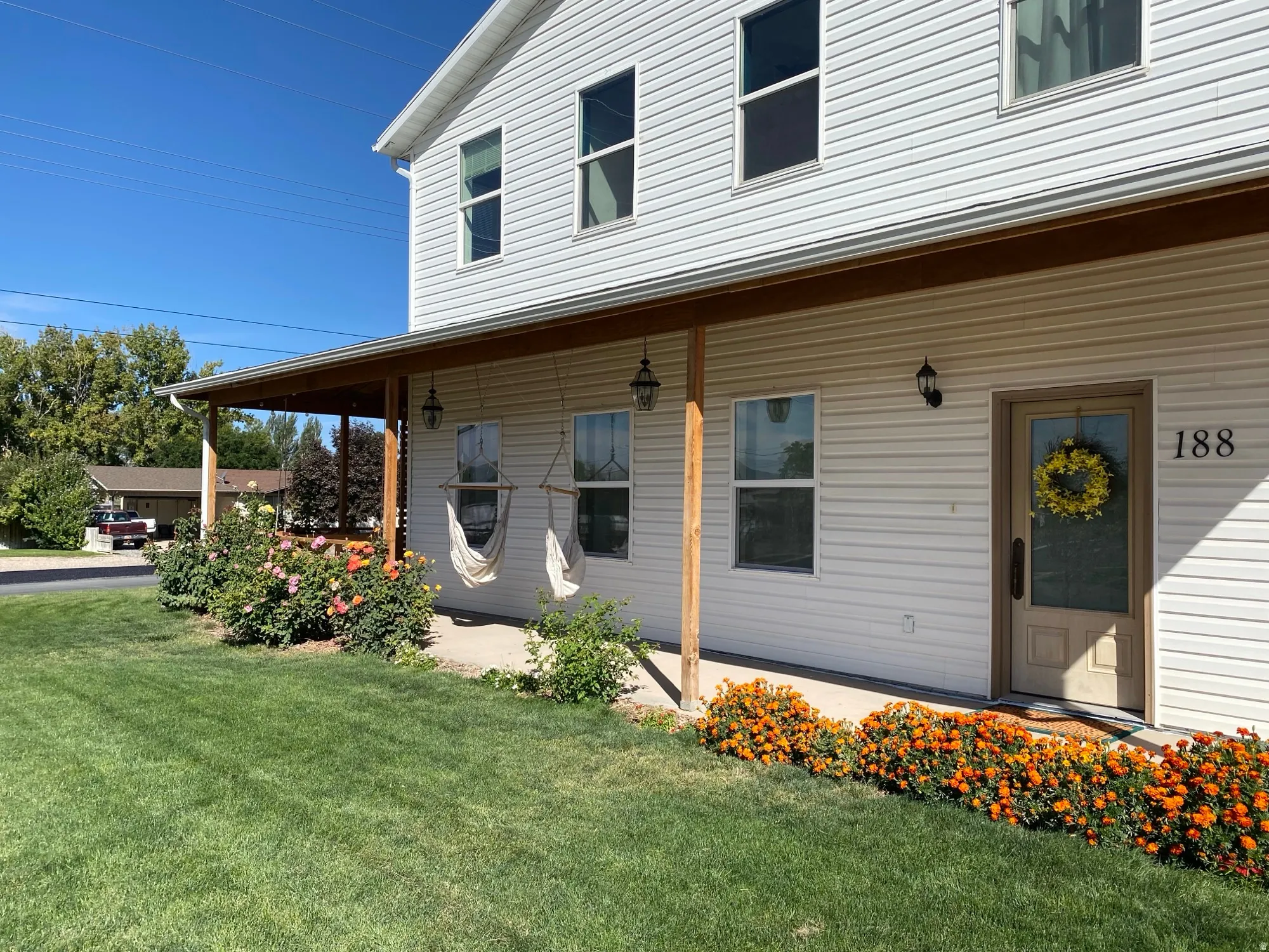 Property entrance featuring covered porch and a yard