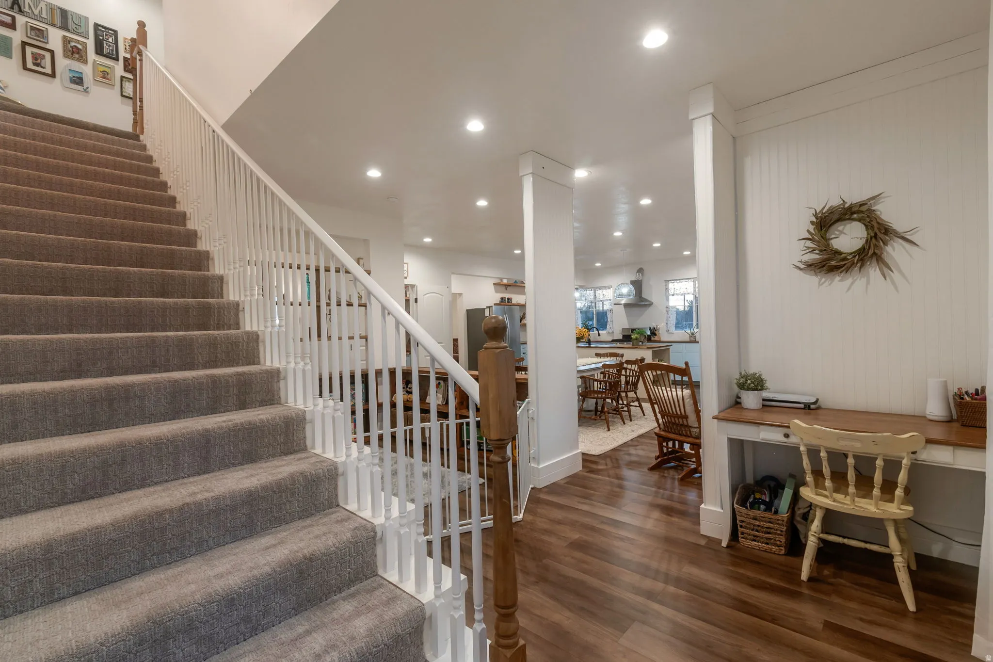 Stairway with recessed lighting and wood finished floors