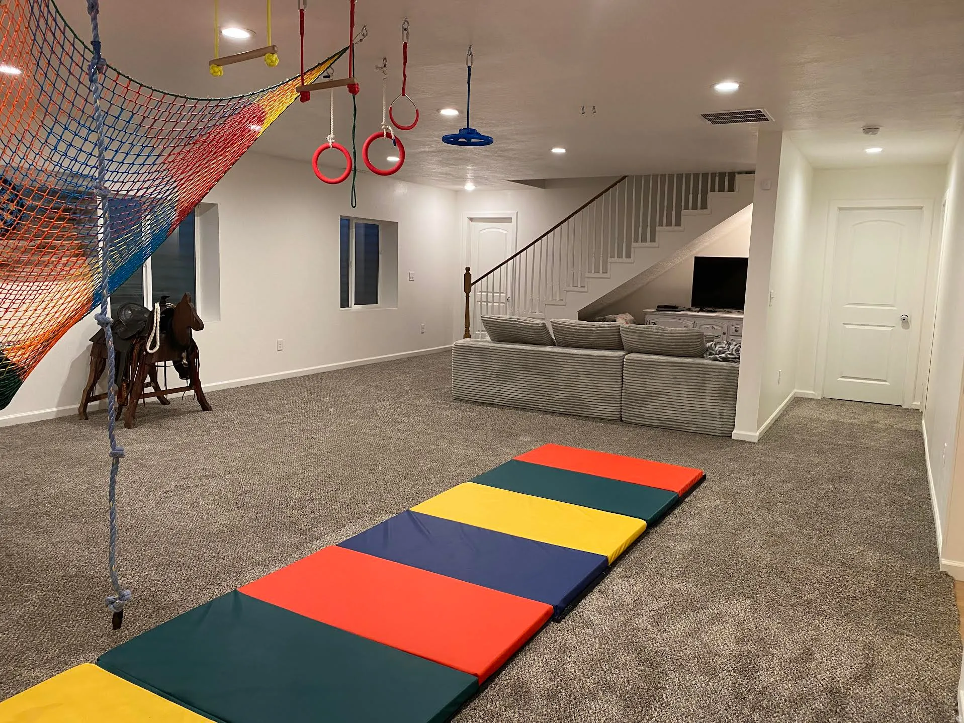 Spacious carpeted room featuring recessed lighting, white walls, and white trim