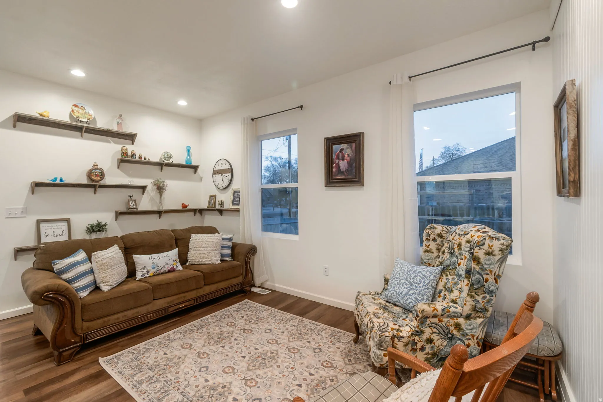 Living area with dark wood-style flooring and recessed lighting
