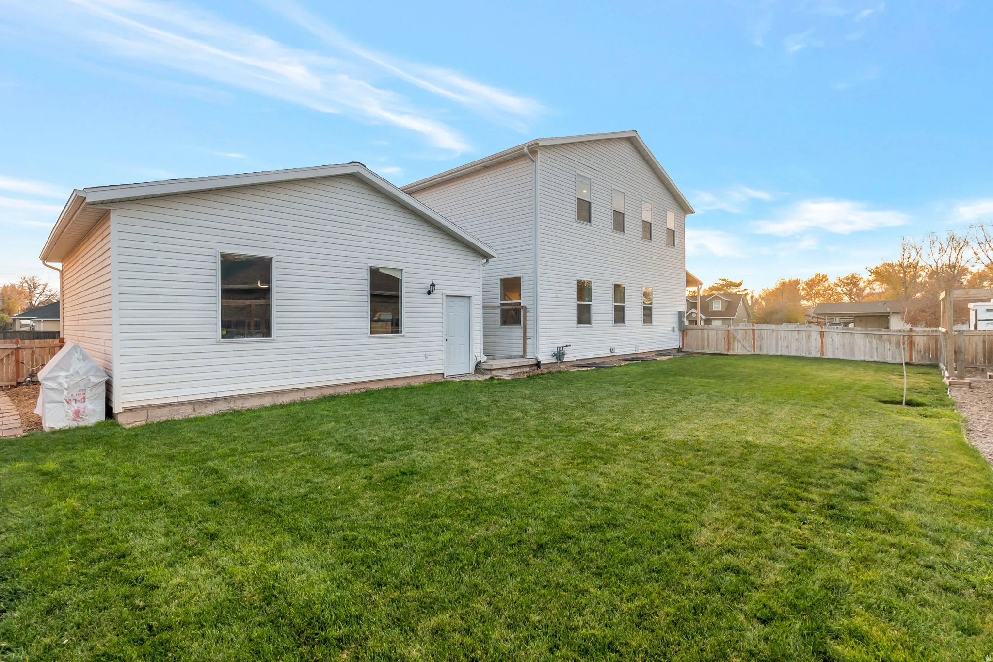 Rear view of property with a fenced backyard