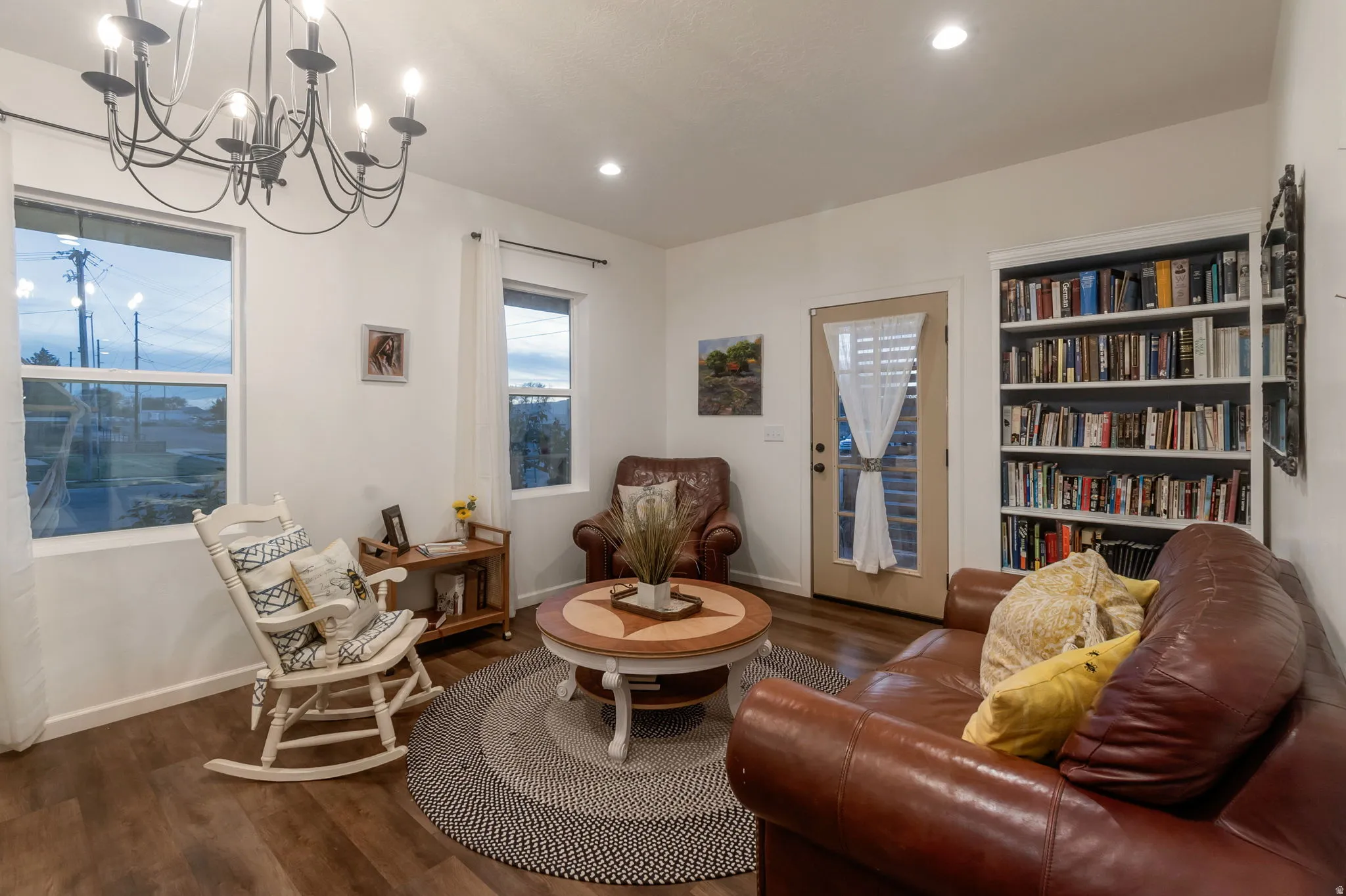 Living area featuring wood finished floors, recessed lighting, and a chandelier