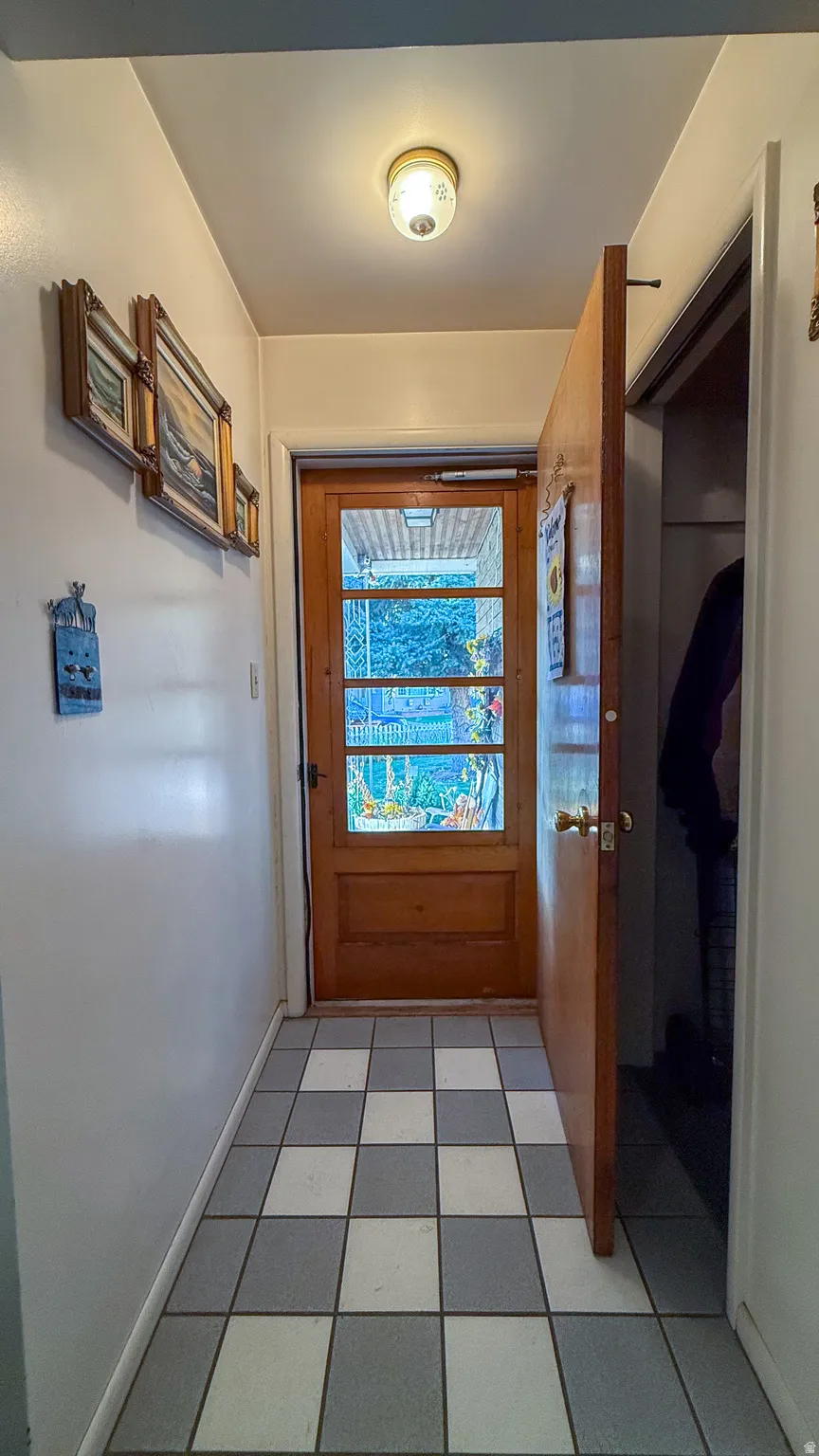 Doorway featuring baseboards