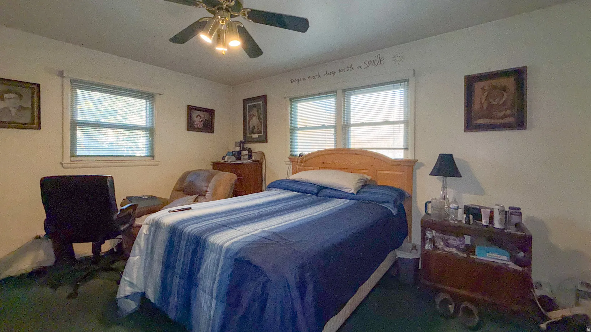 Bedroom with multiple windows and ceiling fan