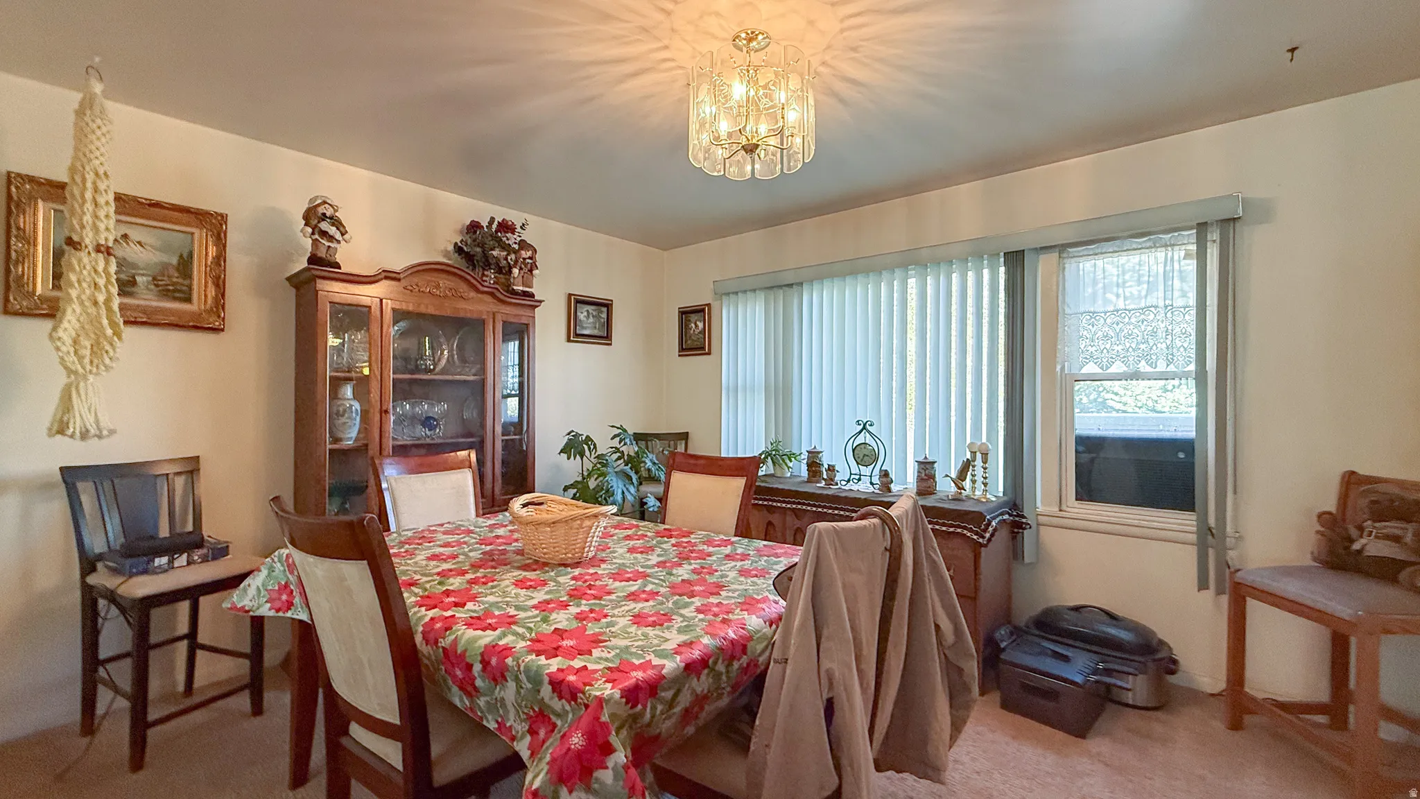 Dining room featuring light carpet and a chandelier