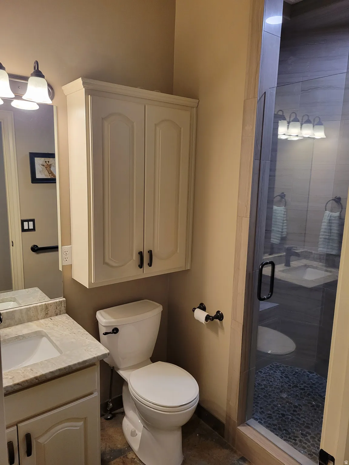Bathroom with a shower stall and vanity