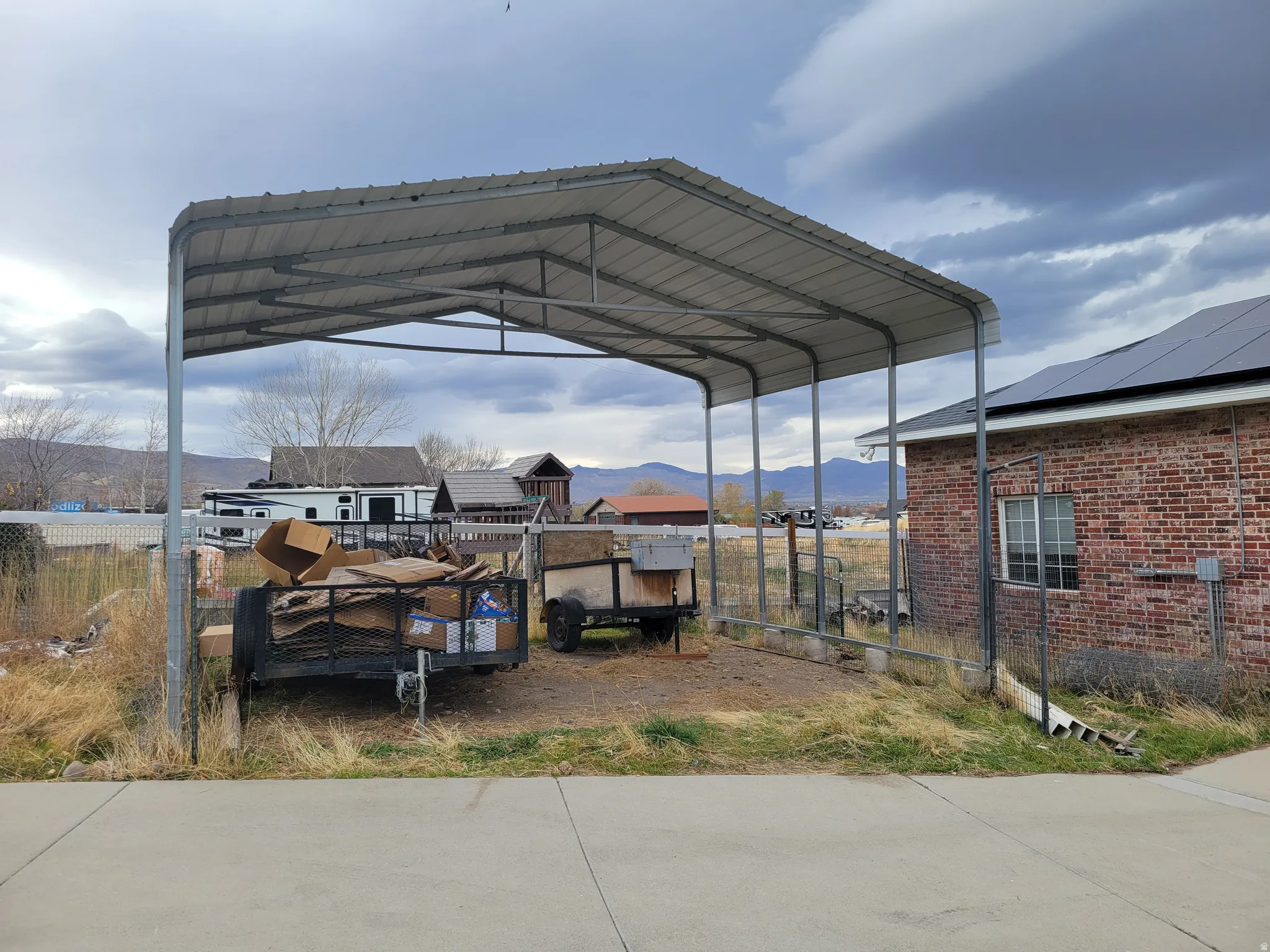 View of parking featuring a mountain view and a detached carport