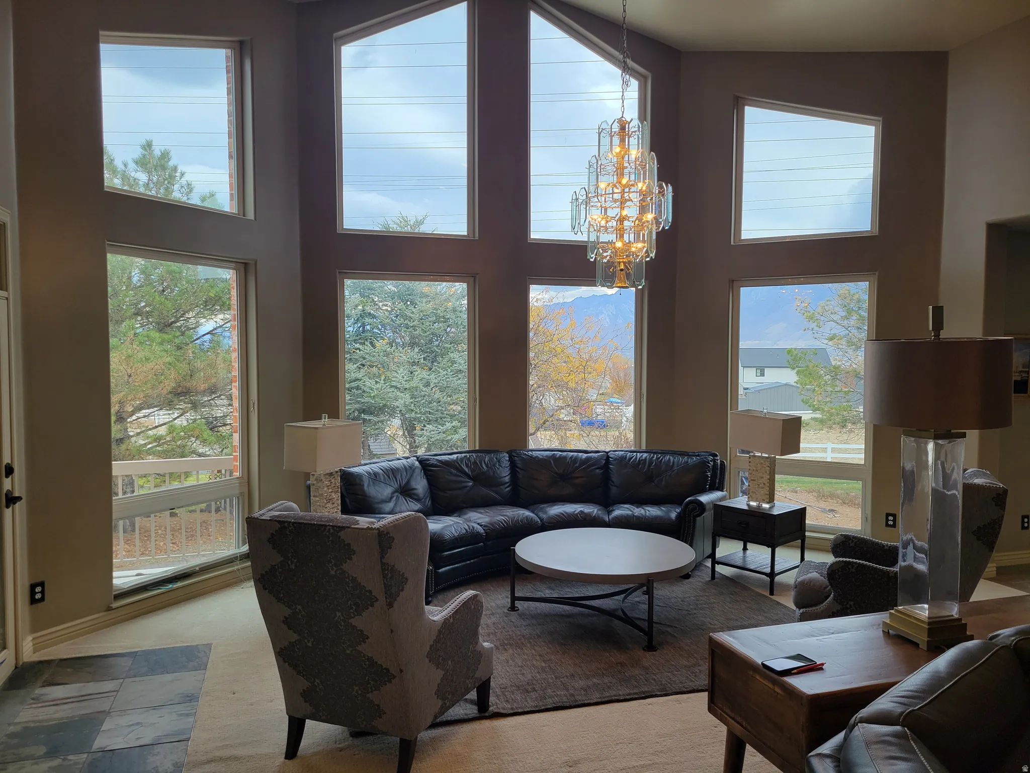 Living area with a high ceiling and a chandelier