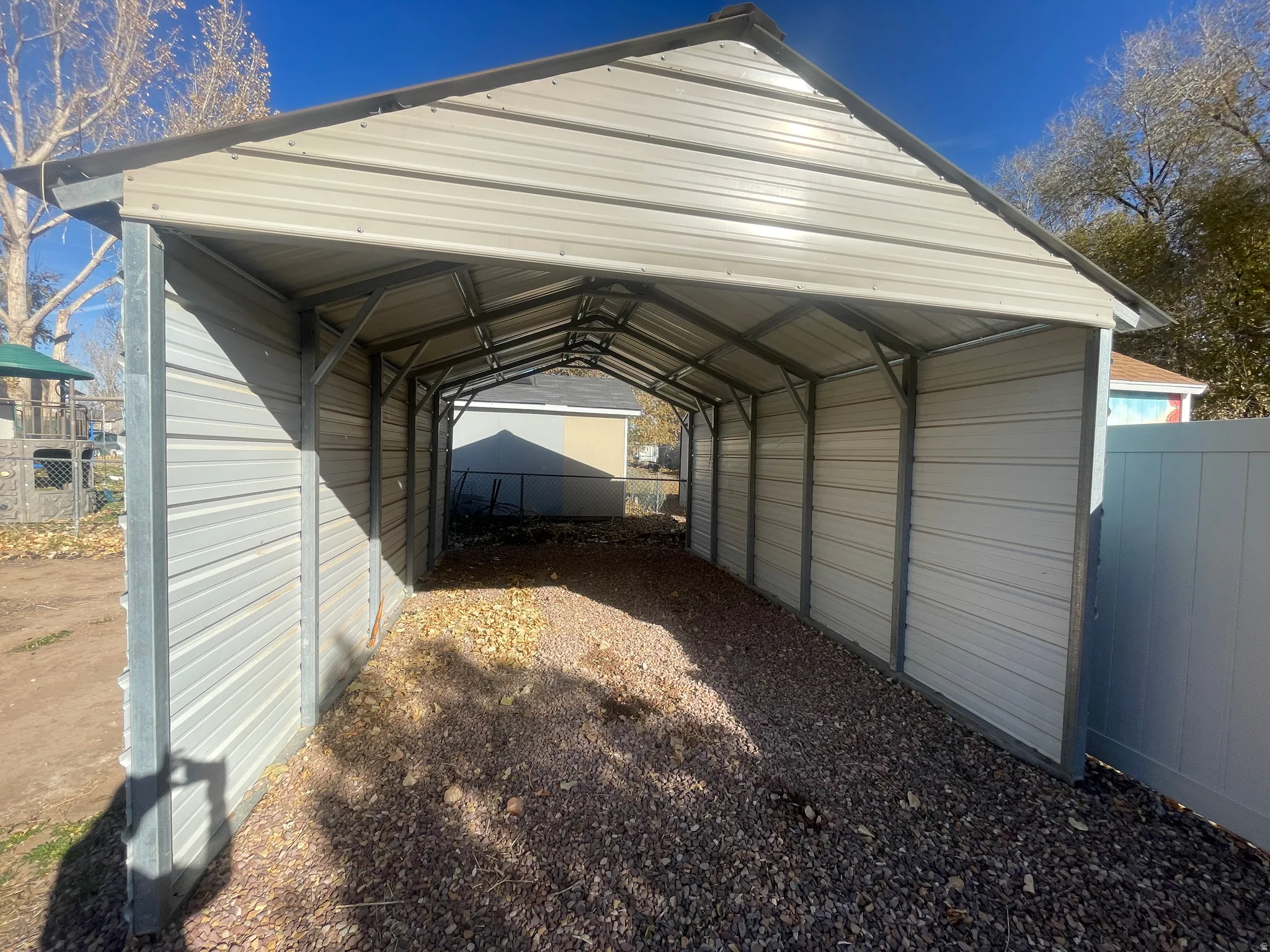 View of vehicle parking featuring a carport