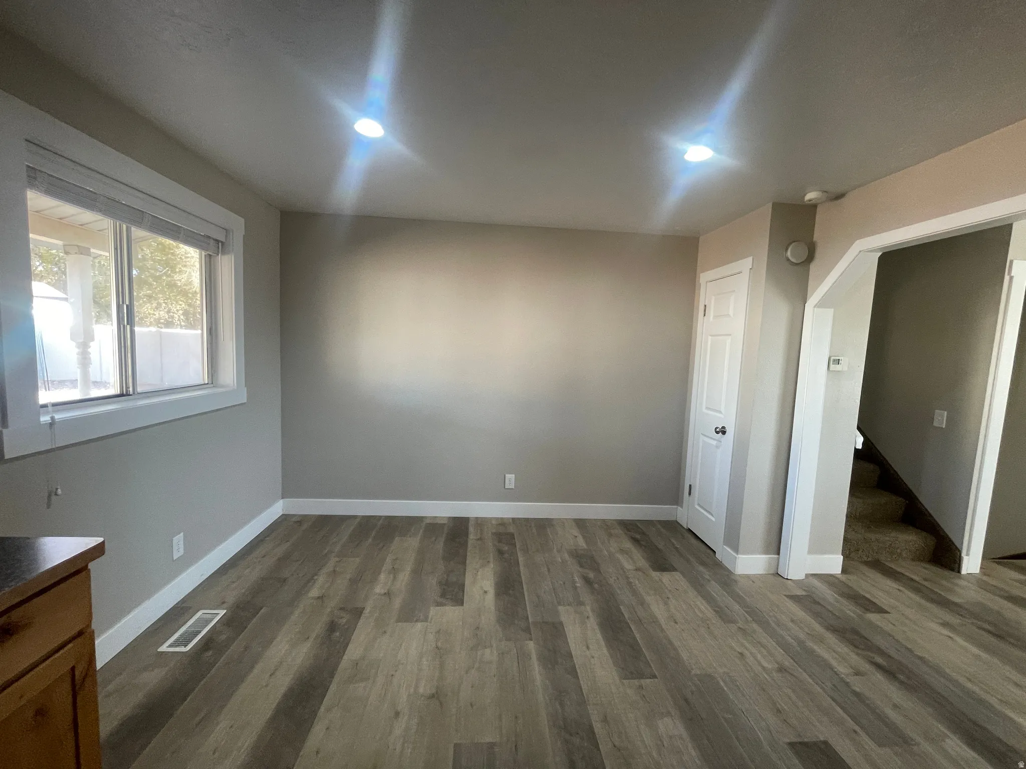Empty room featuring dark wood finished floors and stairs