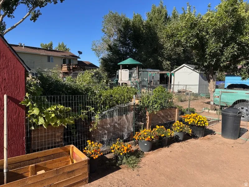 View of yard with a garden and a playground