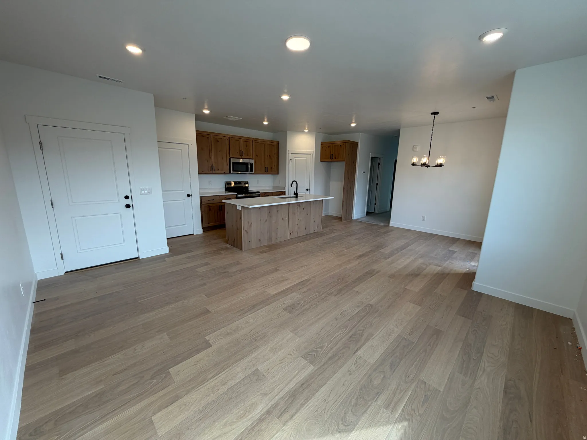 Open-concept living area with wood-finish flooring throughout