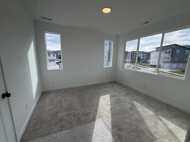 Room featuring light gray carpet flooring, white walls, and white trim