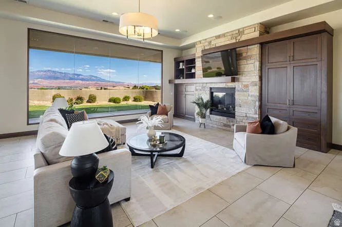 Living area with a stone fireplace and light tile patterned floors