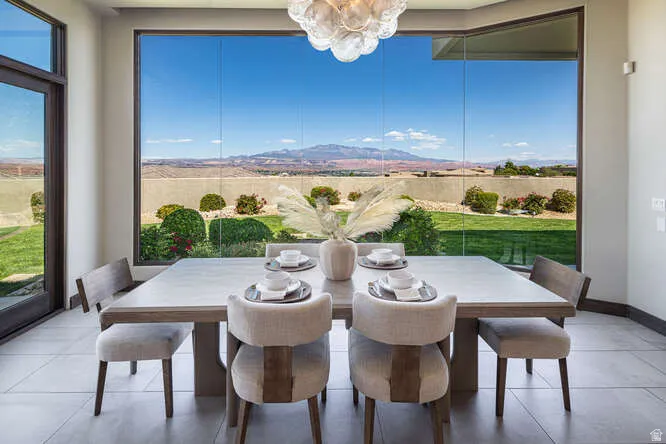 Dining room with tile patterned flooring, a chandelier, and a mountain view