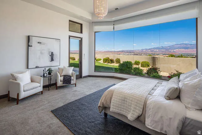 Bedroom with carpet and access to outside