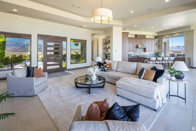 Living room with recessed lighting, a raised ceiling, and tile patterned floors
