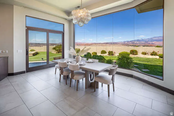 Dining space featuring a chandelier and light tile patterned flooring