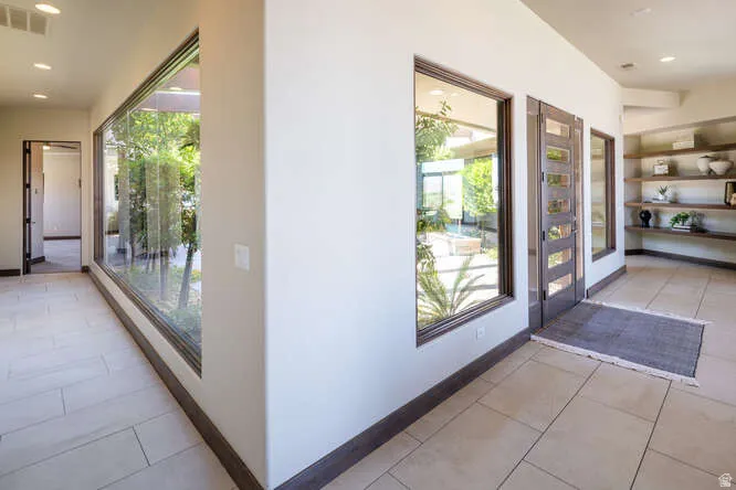 Entryway with tile patterned flooring, recessed lighting, and plenty of natural light