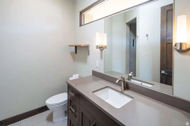 bathroom with vanity and light tile patterned floors and walk in shower