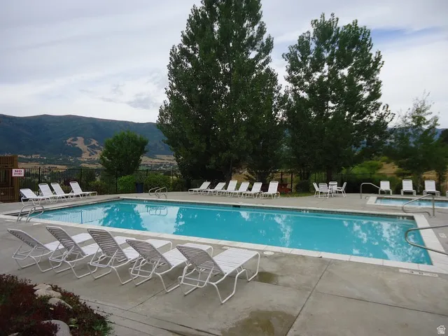 Community pool featuring a patio and a mountain view