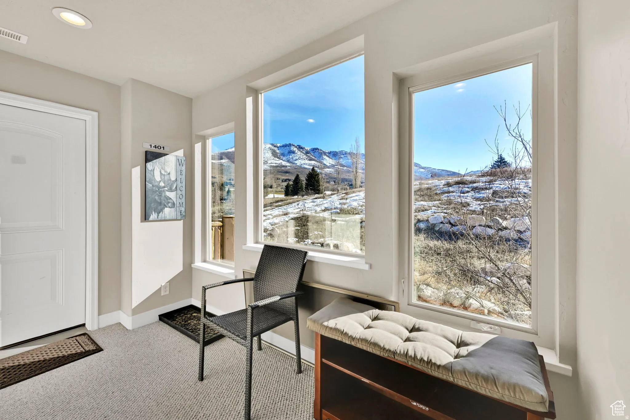 Sitting room featuring a mountain view, light colored carpet, and recessed lighting