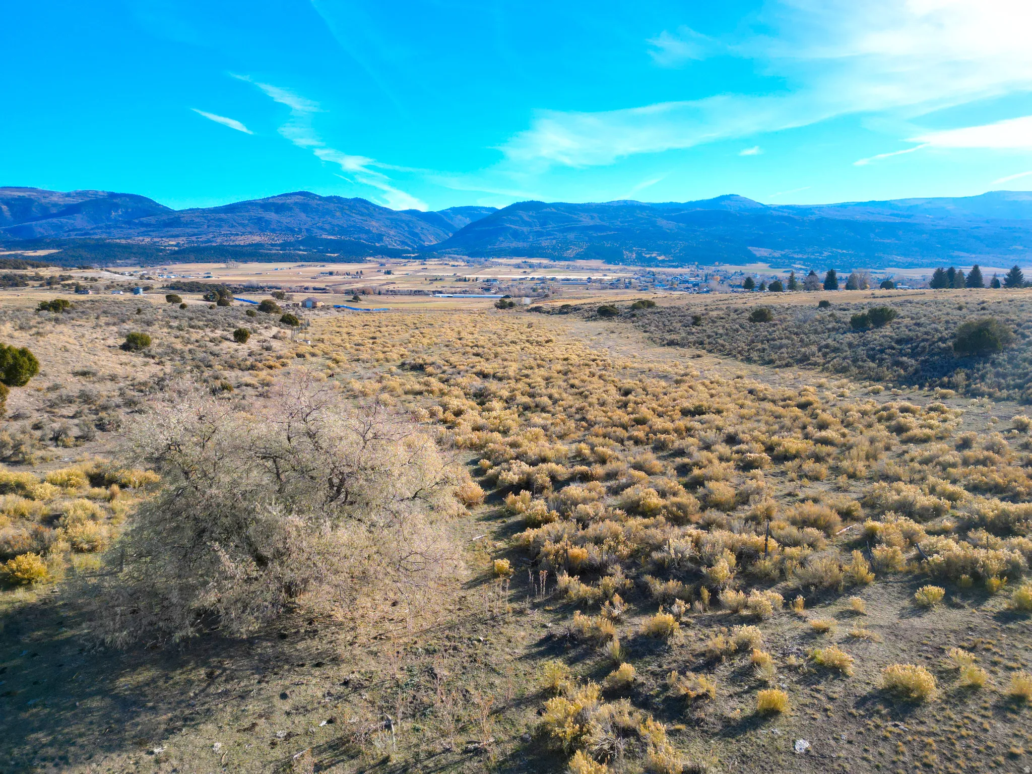 View of mountain backdrop with rural landscape and a desert landscape