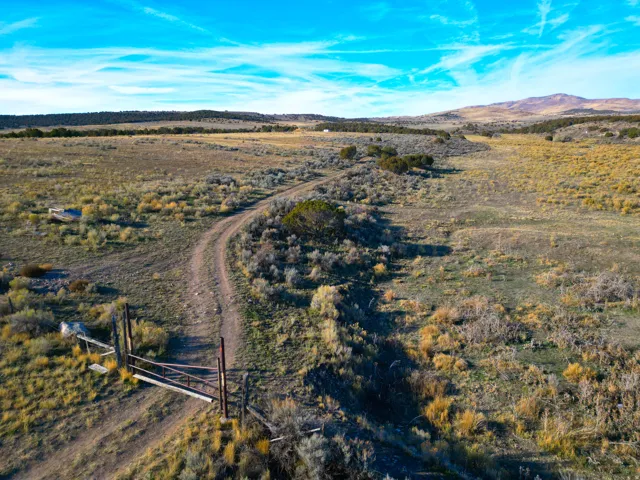 Aerial overview of property's location featuring rural landscape and a mountain backdrop