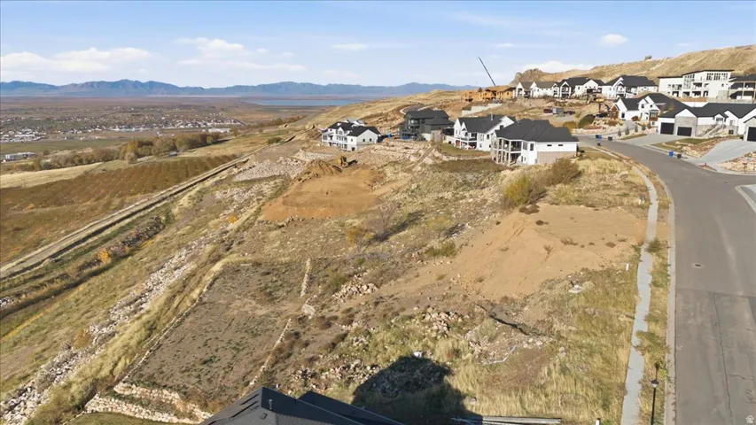 Aerial view of property's location featuring a mountain backdrop and nearby suburban area