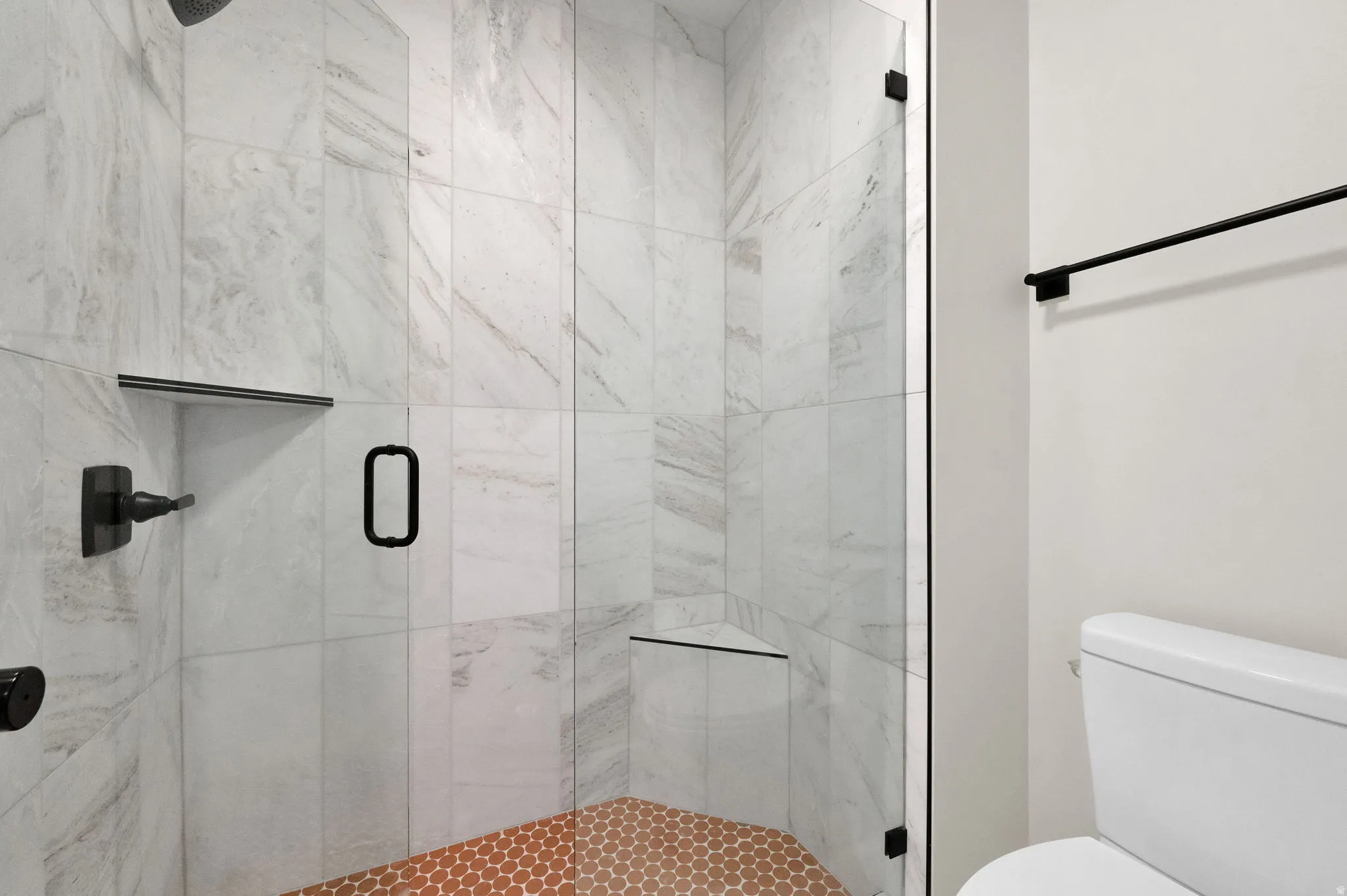 Bathroom featuring a marble finish shower